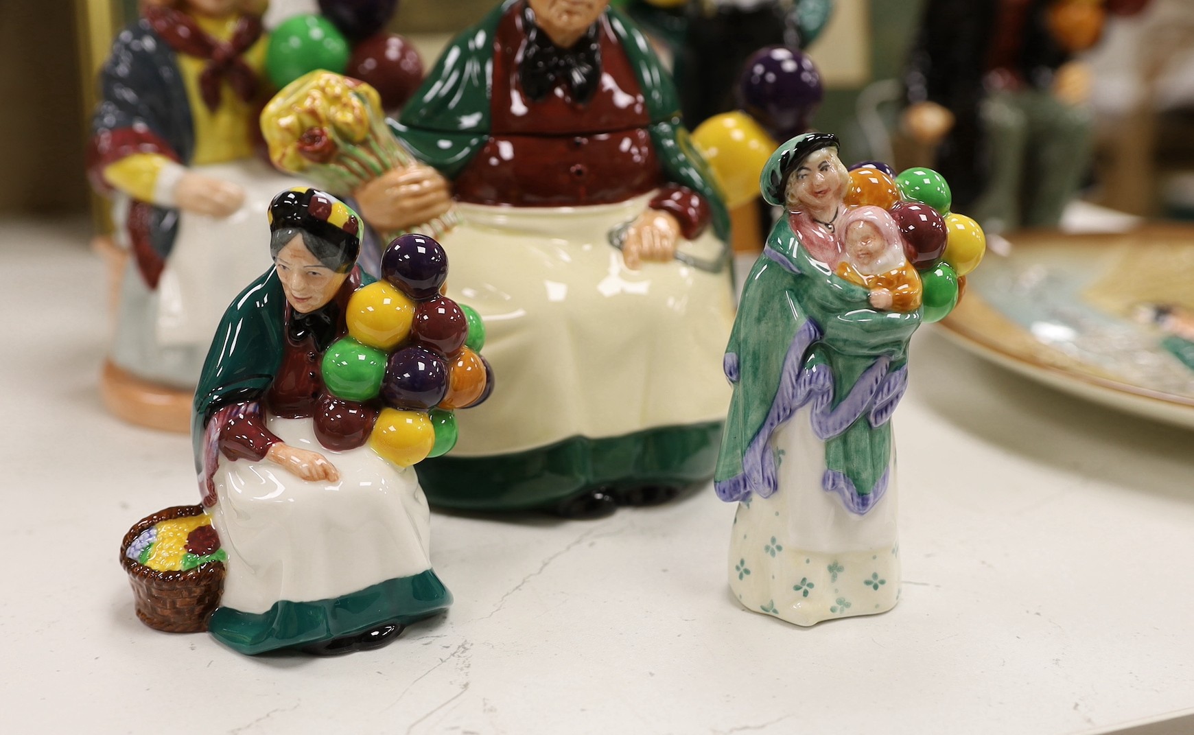 Seven Royal Doulton balloon seller figures in various sizes, a similar teapot and a dish (9), tallest Biddy Penny Farthing, 22cms high